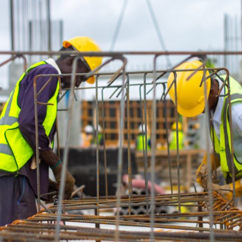 Zwei Handwerker mit Bauhelm und Warnschutzwesten
