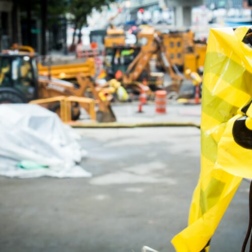 Straßenbaustelle mit Arbeitsgeräten und Fahrzeugen