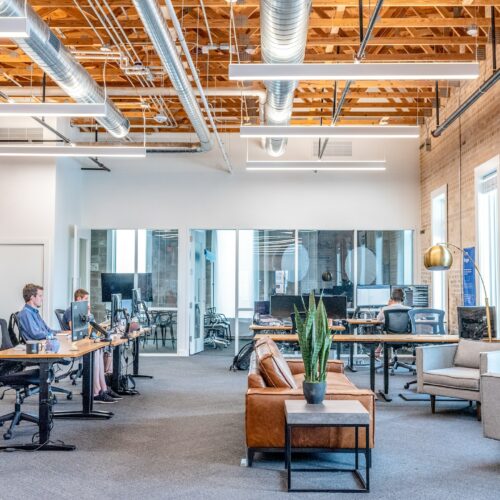 Geräumiges Büro mit Personen, die an ihren Tischen arbeiten
